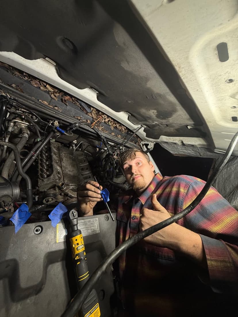 Mobile mechanic working under vehicle performing on-site repair in Everett
